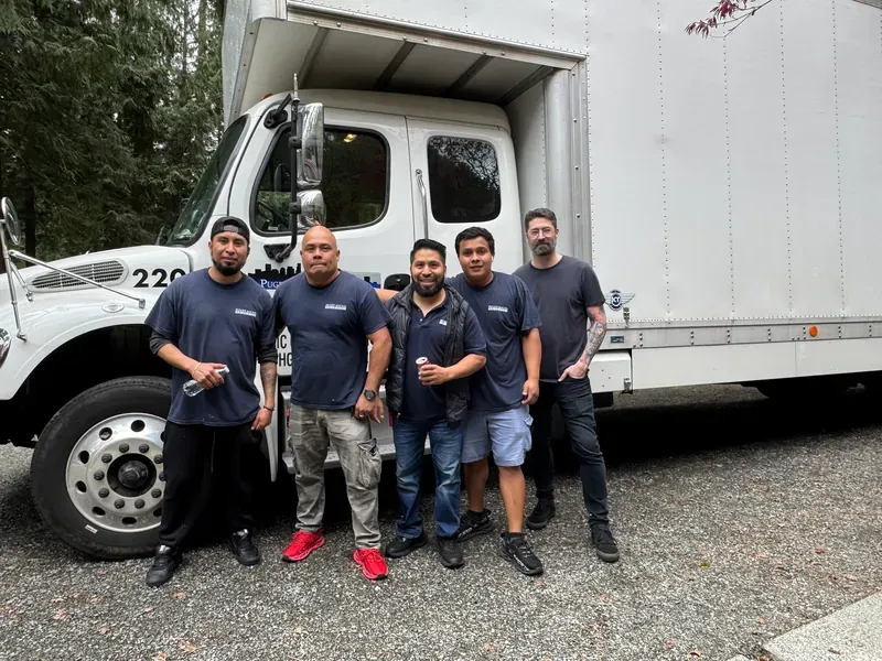 Puget Sound Moving crew standing in front of a company truck